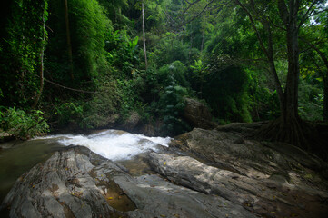 Obraz premium Tranquil Waterfall Scene in Chiang Mai with Lush Greenery