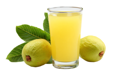 a glass of orange juice next to some green fruit