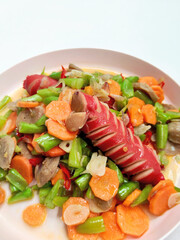 A Plate of Delicious Indonesian Stir-Fried Vegetables and Sausage