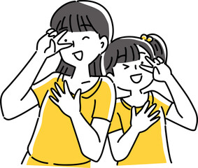目元でピースする2人の女の子