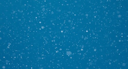 Close-up view of light snow falling on a deep blue background.
