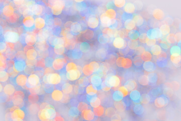 Defocused abstract bokeh background pastel colored, flare from lights, color gradient, blurred circle bokeh as holiday texture. Glittering aesthetic textured lighting pattern