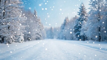 Fototapeta premium Snow-covered landscape with trees and falling snowflakes, creating a serene winter atmosphere.