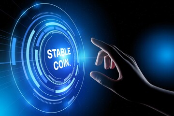 Hand touches digital stable coin interface in futuristic glowing blue tech