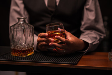 Bartender is pouring whiskey into a glass in a restaurant	