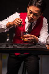 Bartender is pouring whiskey into a glass in a restaurant	