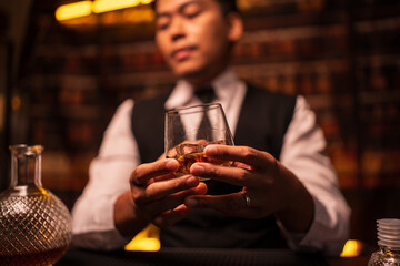 Bartender is pouring whiskey into a glass in a restaurant	