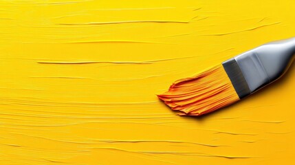 Paintbrush with Yellow Paint on Canvas