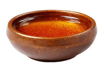 a brown bowl of liquid on a white surface