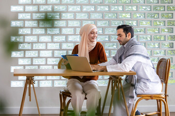 Middle east muslim couple is sitting in the cafe using laptop for business and to watch movie and social media for modern lifestyle and islamic family