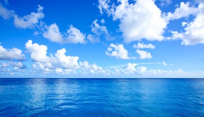 Fototapeta premium Wide expanse of a vibrant blue sky meeting a placid blue sea