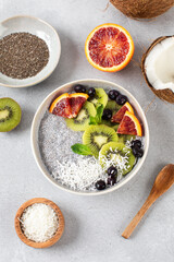 Healthy breakfast bowl with chia pudding, kiwi, blood orange, and berries