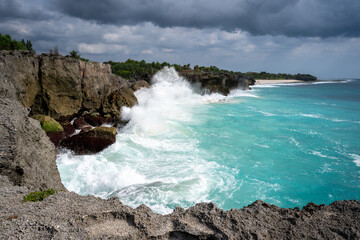 Sumba Island rocky shore with turquoise water and high waves