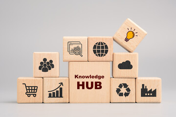 Knowledge hub and resource network concept with icons on wooden blocks