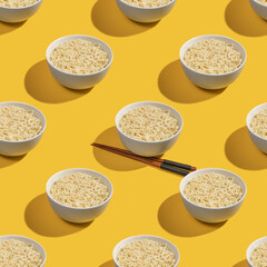 Seamless pattern with instant noodles in ceramic bowl on yellow background.
