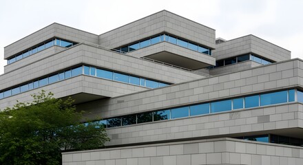 Obraz premium Modern Angular Concrete Building Architecture with Blue Windows - Corporate Design, Contemporary Urban Structure