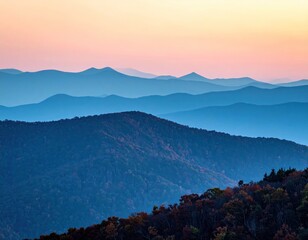 Layered blue mountain ridges fade into a pastel sky at dusk, with a tree-covered peak in the foreground creating depth and texture