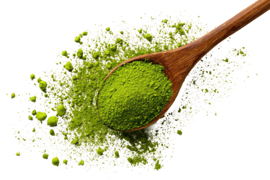 Wooden spoon holds matcha powder, scattered on a backdrop