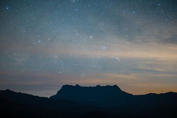 Fototapeta premium Spectacular view of Doi Luang Chiang Dao mountain in Chiang Mai province of Thailand at night time. Doi Luang Chiang Dao mountain is the 3rd highest mountains of Thailand.