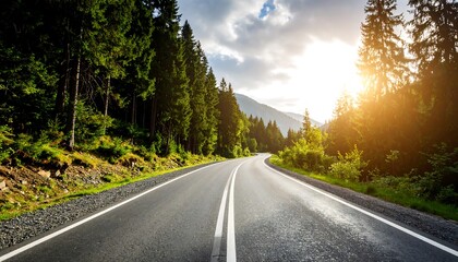 Fototapeta premium Winding road through a lush forest at sunset