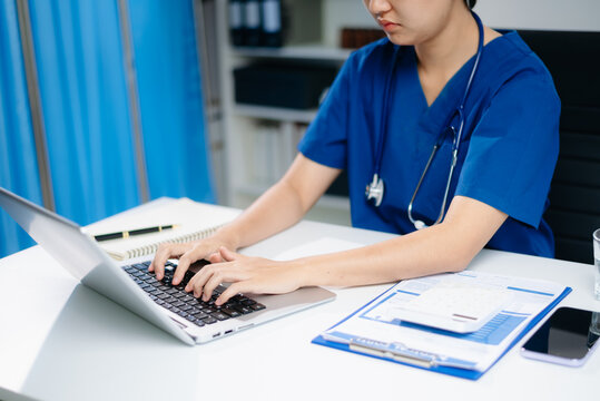 Healthcare costs and fees concept.Hand of smart doctor used a calculator and smartphone, tablet for medical costs at hospital in morning light