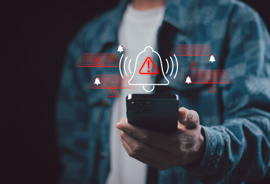 Corporate man handling emergency alert notification on mobile phone, concept of warning message, cyber threat monitoring, digital security breach, urgent system error, and risk management