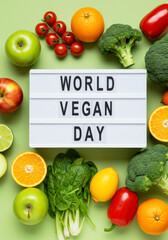 World Vegan Day Message in Light Box with Fresh Fruits and Vegetables Flat Lay