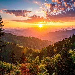 Gorgeous sunset over layered green mountain ranges, with vibrant colors in the sky and trees filling the foreground