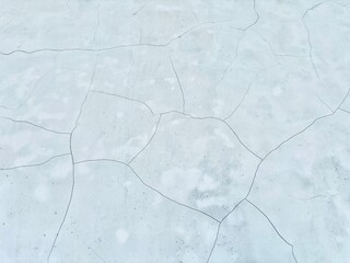 Fototapeta premium Old cracked and broken cement wall background. Rough and broken concrete surface. Damaged cement surface background for textures or grunge design. Empty white concrete wall texture.