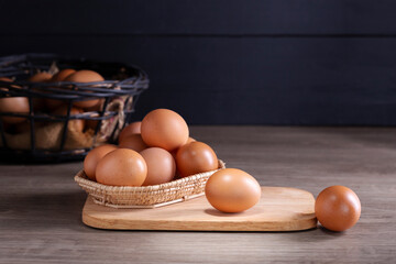 Fresh organic eggs from the farm are placed on a wooden table in the kitchen for preparing breakfast. Healthy food.