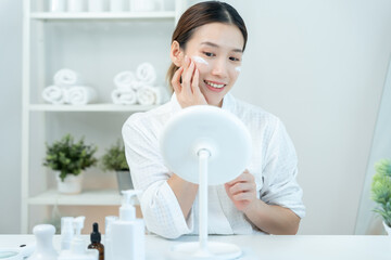 Beautiful woman sit in front of a mirror. face of a healthy woman applying cream and makeup. Advertisement for skin cream, anti-wrinkle, baby face, whitening, moisturizer, tighten pores serum © Shisu_ka