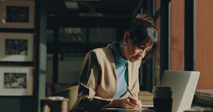 Laptop, office or woman writing in notebook for research, record financial transaction or review expenses. Account management, digital report or bookkeeper in workplace with computer, payroll and tax