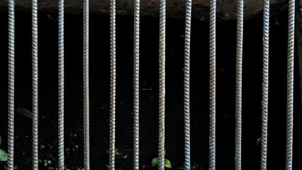 Textured Metal Grate Drain Cover Bars Over Dark Industrial Background
