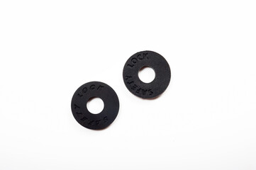 Round black rubber safety lock for guitar strap.