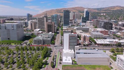 An absolutely stunning aerial view beautifully showcases a vibrant cityscape that is elegantly surrounded by majestic mountains, making it ideal for numerous creative projects and artistic endeavors