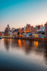 Obraz premium Gdansk with Motlawa river in Poland. Old town colourful house with Zuraw or crane and with Holy Spirit Gate