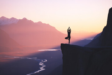 Meditative Silhouette of a Person Practicing Yoga at Sunset