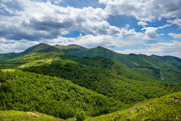 Fototapeta premium Summer mountain landscape with green hills and clouds