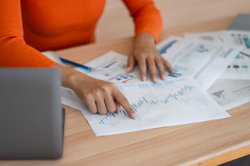 Business woman working on laptop or notebook in her office.