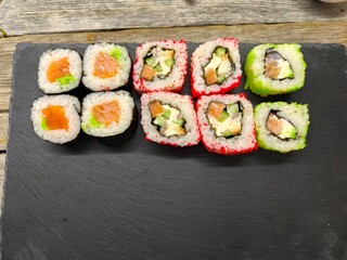 sushi on a granite board on a wooden table background