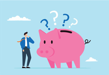 Confused businessman with piggybank and question marks