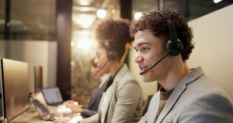 Happy, man and team with headset in call center, working late and communication for lead generation. Night, consultant and people with mic for discussion, telemarketing and conversation for sales