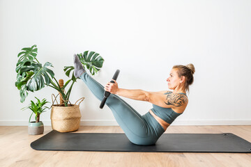 Woman Performing Core Exercise With Fitness Ring in Well-Lit Indoor Space