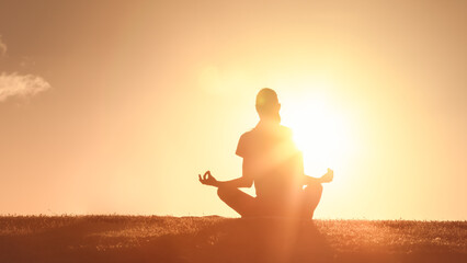 Closeup of person meditating in the golden sunlight	