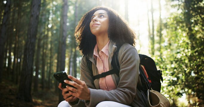 Hiking, thinking and girl with phone in forest for location search, check map or travel adventure. Low angle, hiker and reflection with smartphone in nature for direction navigation or trekking break - Powered by Adobe