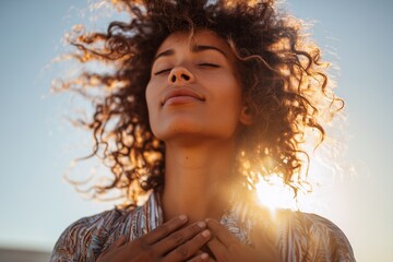 Peaceful young African American woman enjoying sunlight with eyes closed. Concept of mindfulness, self care, mental health, inner balance, wellness, relaxation, positive energy.