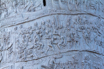 An intricate, detailed close-up of the Roman relief carvings on Trajan's Column, depicting a dense narrative of ancient military scenes. Ideal for historical, educational, and archaeological publicati