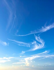 Wispy clouds against a vibrant blue sky