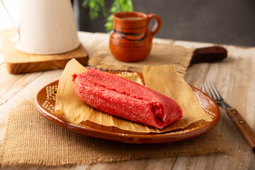 Sweet Tamale. hispanic dish typical of Mexico and some Latin American countries. Corn dough wrapped in corn leaves. The tamales are steamed. Usually accompanied with atole, hot chocolate or coffee