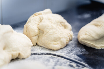 Two pieces of dough are sitting on a countertop